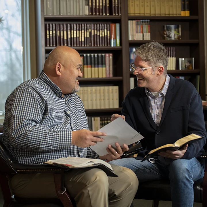 Two pastors reading Bible and talking