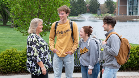 Students talking with teacher around Cedar Lake