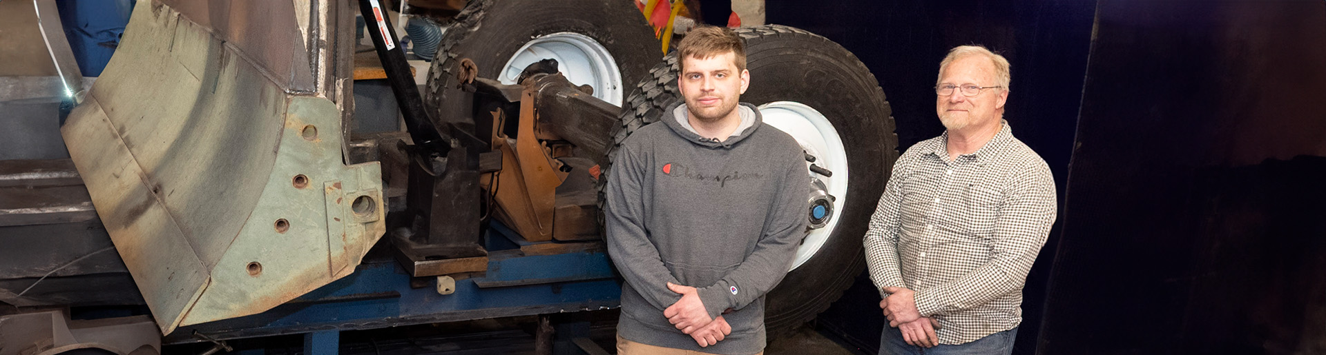 Brian Reiff and Ken Atkinson with the earth mover they built for Karanda Mission Hospital in Zimbabwe.