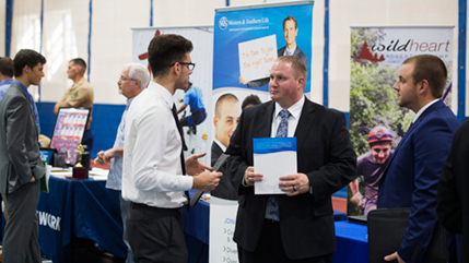 Students talk to recruiters during career fair