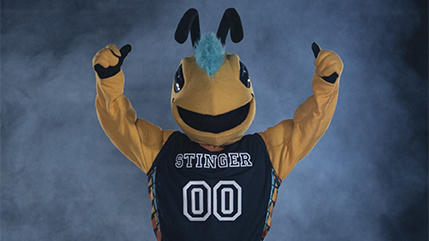 Cedarville mascot Stinger with arms raised in the air