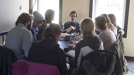 Cedarville University assistant professor of English, Andy Graff, teaching a small group of students around a table. 