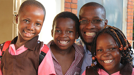 Ugandan pastor and advocate Peter Sewakiryanga pictured with children he's rescued from child sacrifice. 