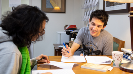 2017 alumnus David Grandouiller tutoring another student
