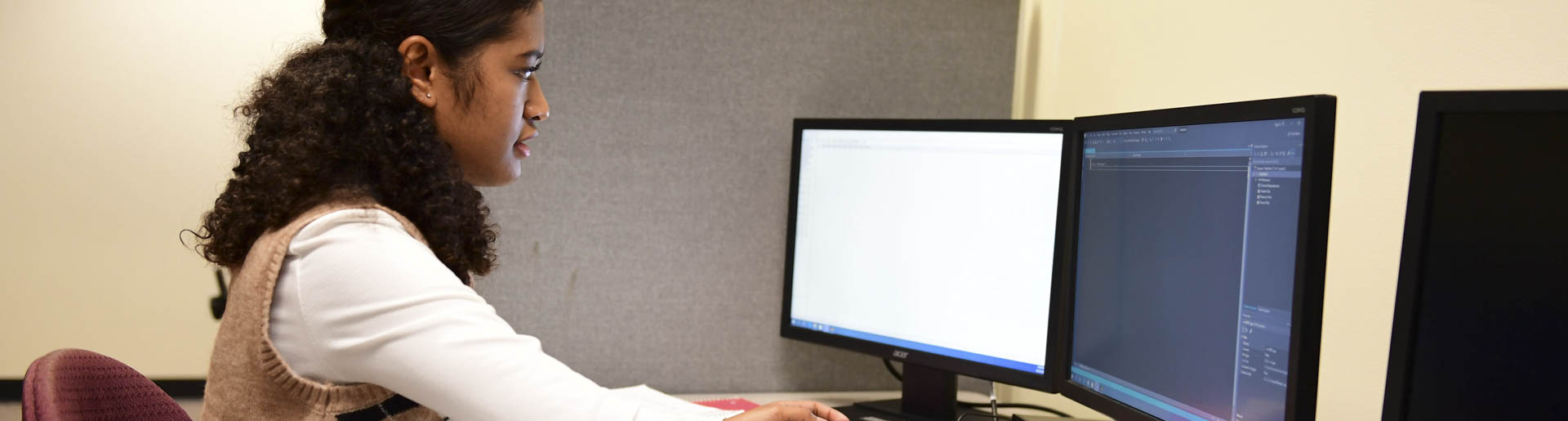 A computer science student practices her coding.