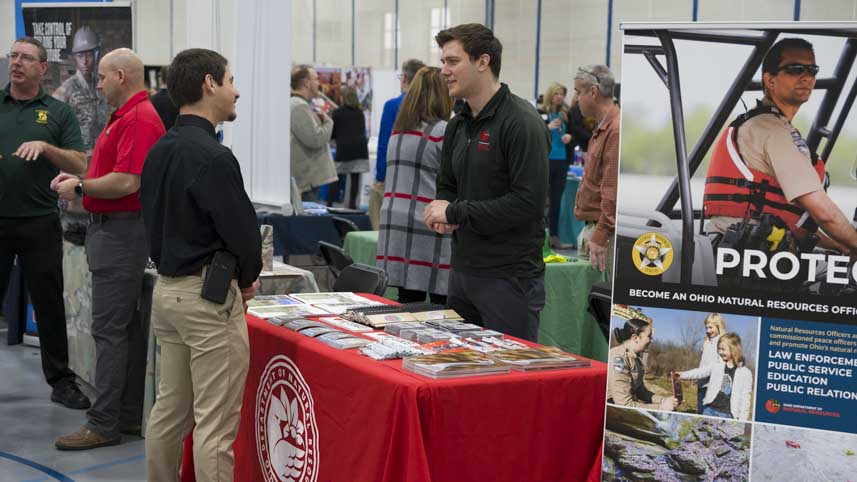 Students talking to recruiters at a career fair.