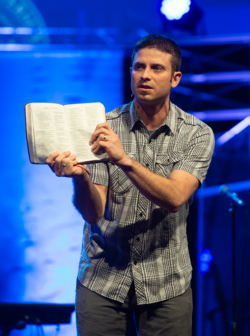 Aaron Cook, director of discipleship ministries at Cedarville University challenges students to read the Word of God while speaking in a chapel service.