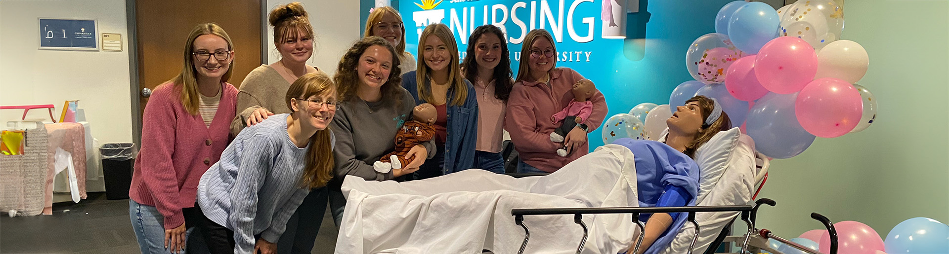 Nursing students throw a baby shower for the programs new manikin with gifts going to help a local crisis pregnancy resource center.