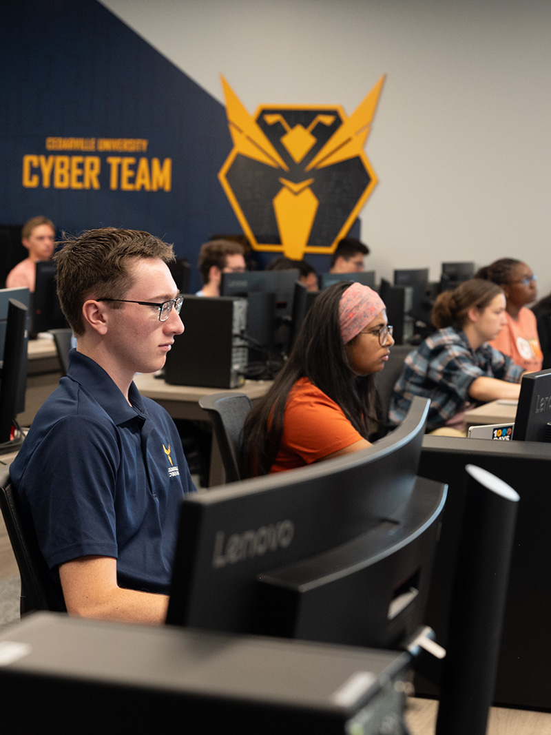 Students learn about cyber security from professors in the university's cutting-edge program.