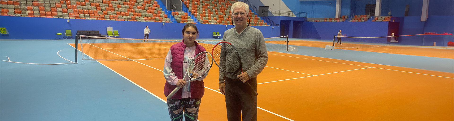 Diana Ivanikhina and her mentor David McKee on the court in Tajikistan where they first played tennis together.