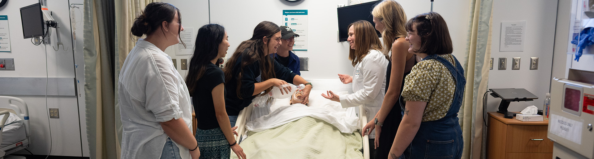 Dr. Marsha Williams instructing students in nursing lab 1920