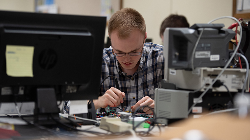 Engineering student at work in lab 858