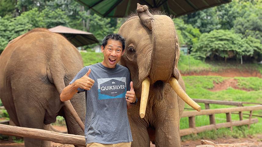 Jonathan Wu giving thumbs up with elephants 858