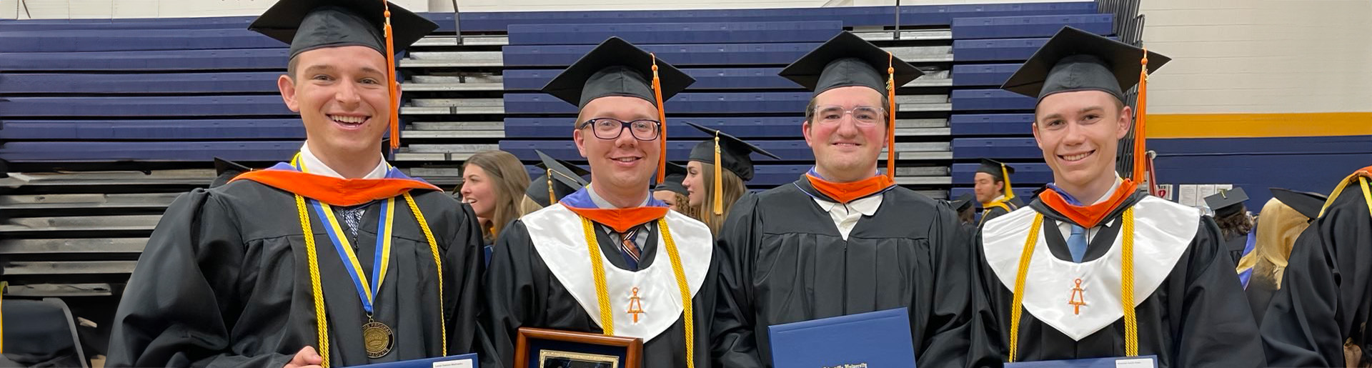 Leadership team for Midian Prime – from left to right: Lucas Mattocks, Willem Vandermeij, Matthew Brugel, Krestian Robe in cap and gown as they celebrate graduating from Cedarville University