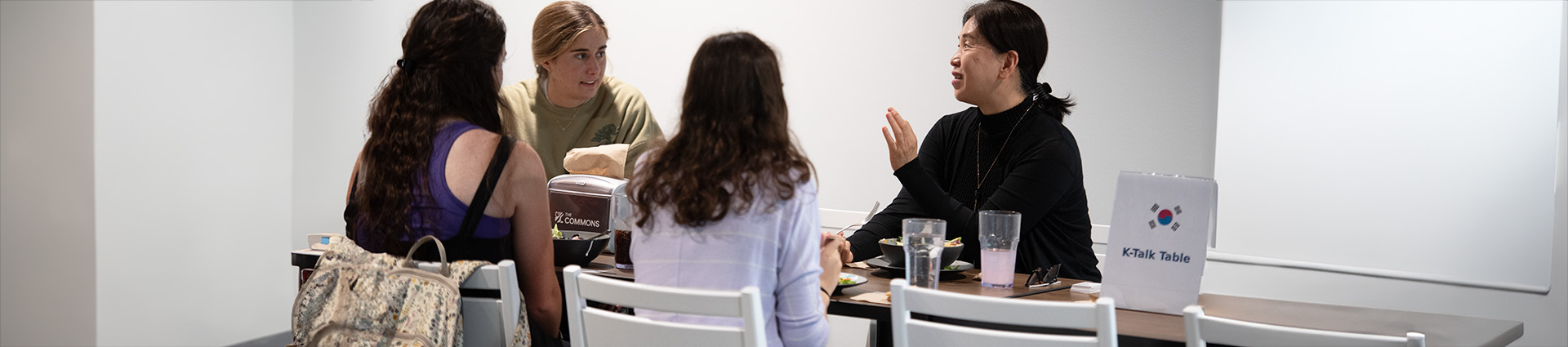 Dr. Kim teaches Korean over lunch in the Commons.