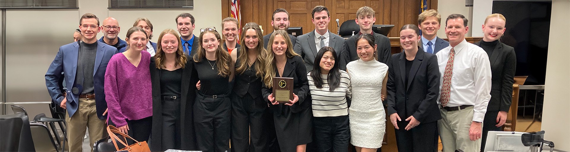 Cedarville University&#39;s mock trial team smiling and holding award plaque.