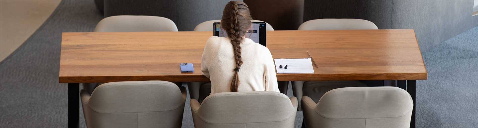 Cedarville University student studying at a table in the Scharnberg Business and Communication Center.