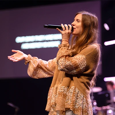 Singer leading worship onstage.