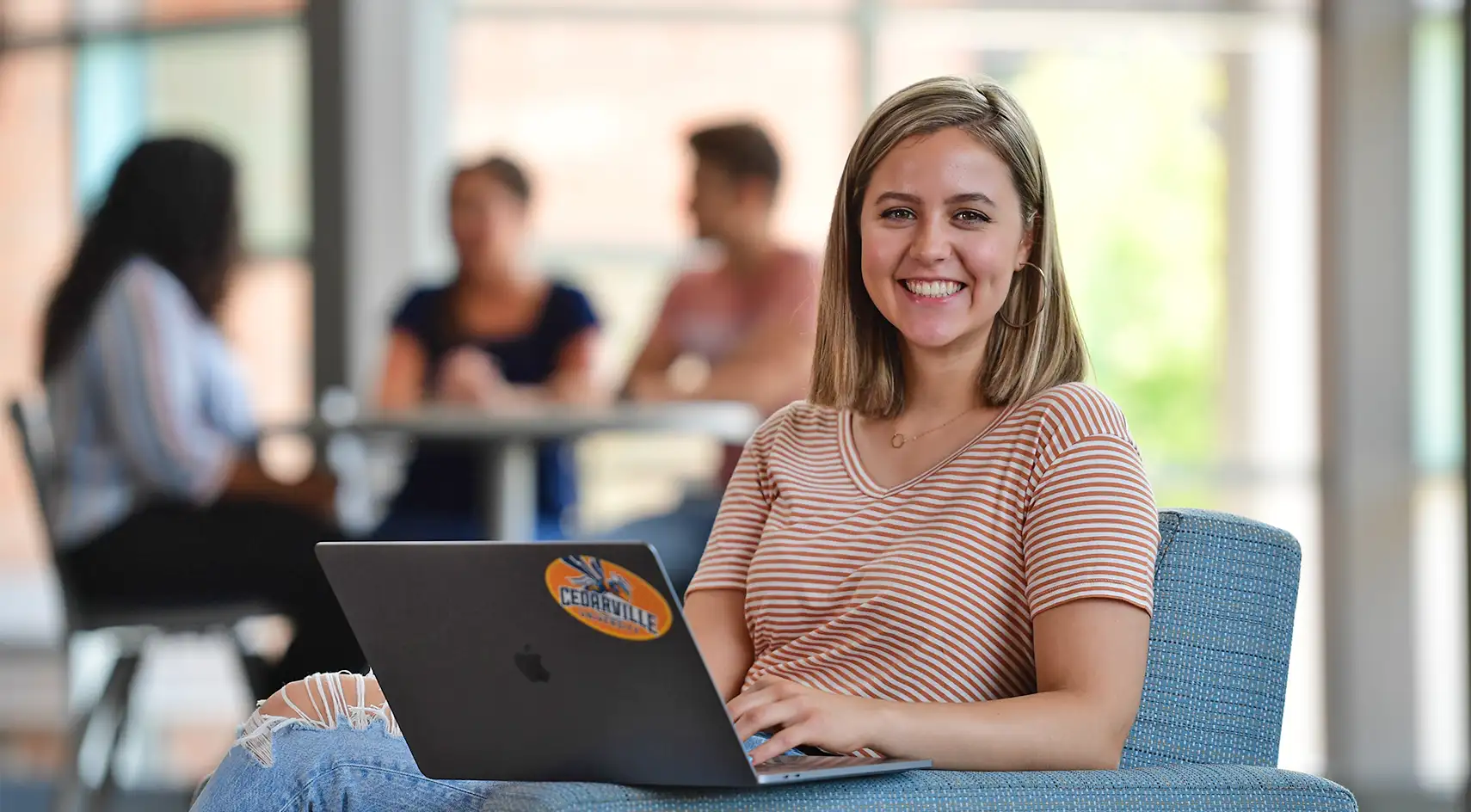 woman working with her laptop on her lap