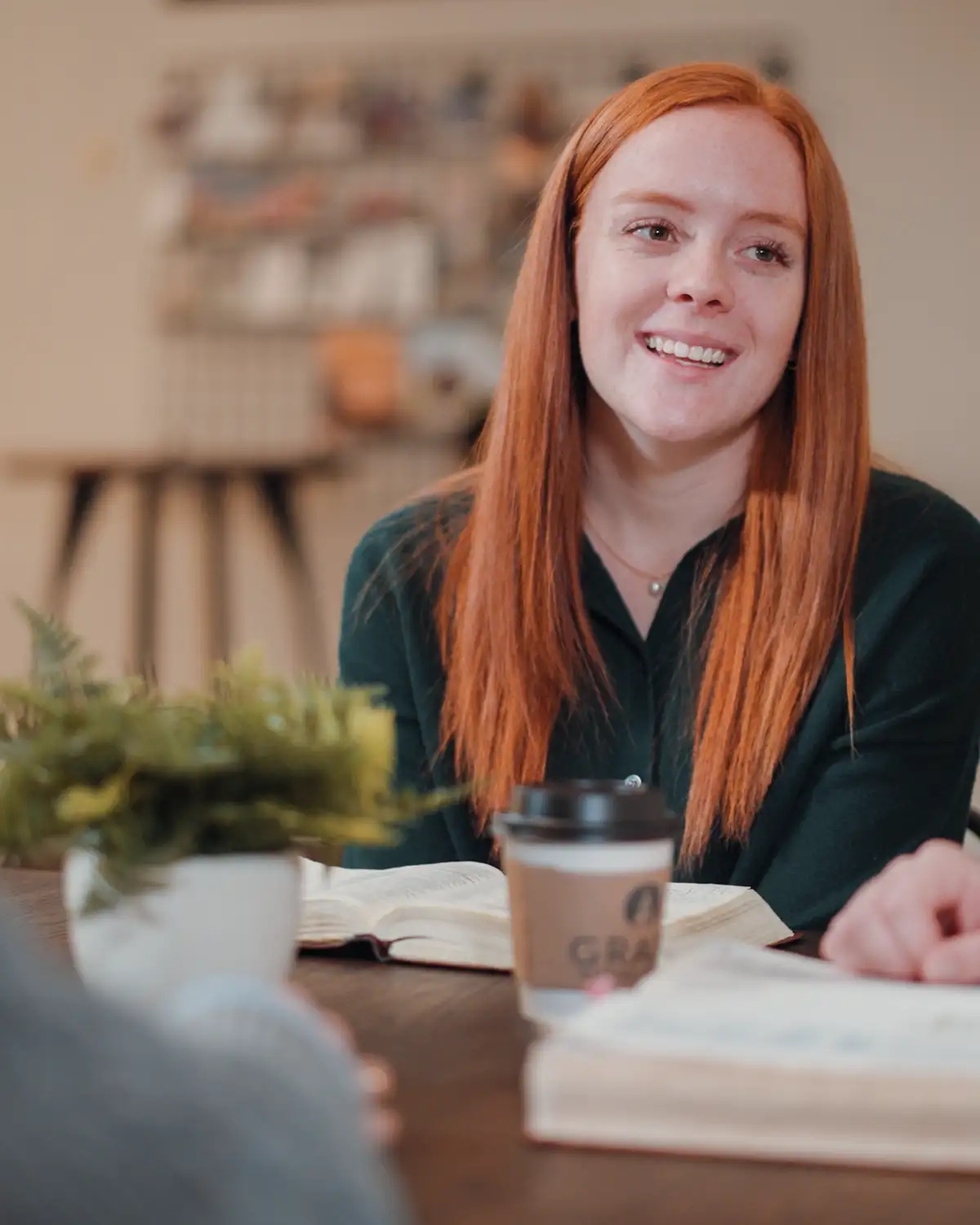 Bible-Study-Girl Cedarville student smiling during Bible study with open Bible and coffee cup