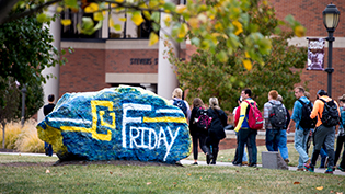 Cedarville's rock painted with CU Friday logo