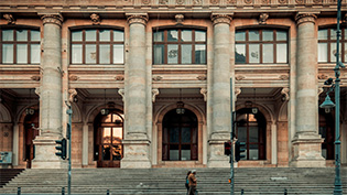 Grand building facade with large columns and wide steps.