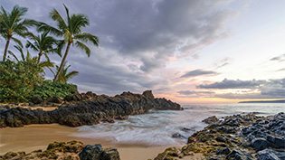 Scenic view of a rocky beach in Hawaii at sunset