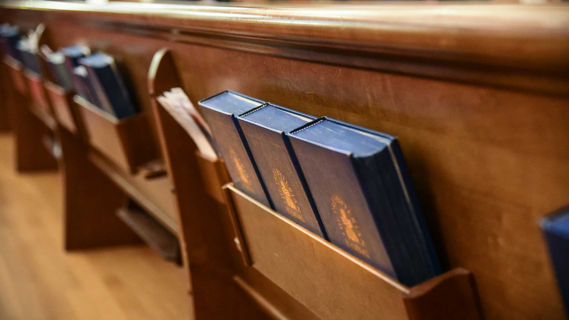 Hymnals in church pews.